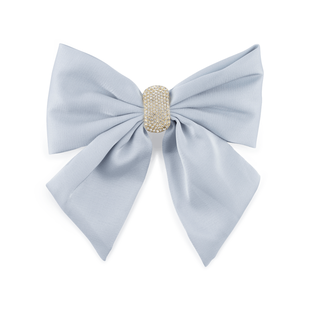 Hårspænde med stor lyseblå sløjfe dekoreret med skinnende krystalsten. En feminin og funklende accessory, der fuldender din frisure.