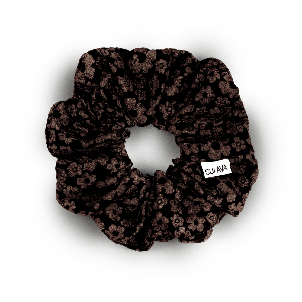 Blossom Scrunchie i brun – Blød scrunchie med smukke blomsterdetaljer i en varm brun nuance.